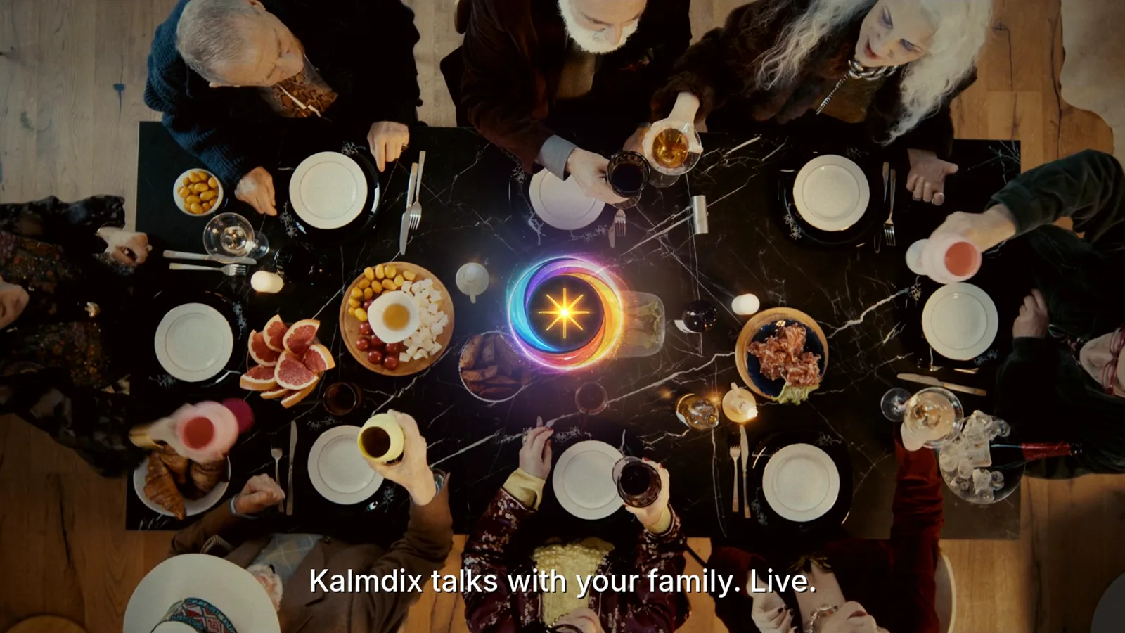 Still from the Kalmdix film: a family dinner seen from above, with the glowing Kalmdix orb in the middle of the table